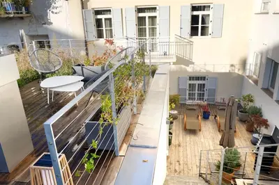 a balcony with a table and chairs on a building at Apartment Lauben - Alpstay in Merano
