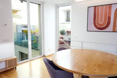 a dining room with a wooden table and chairs at Apartment Lauben - Alpstay in Merano