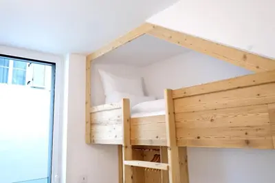 a bunk bed in a room with a window at Apartment Lauben - Alpstay in Merano