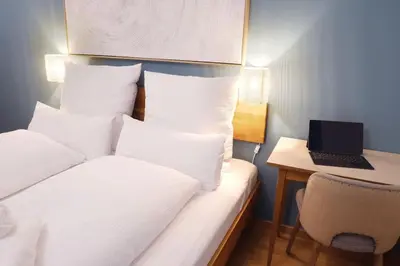 a hotel room with a bed with a laptop on a desk at Apartment Lauben - Alpstay in Merano