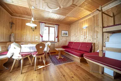a living room with a red couch and a table at Apartment Carolina in Ortisei