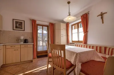 a kitchen with a table and a table and chairs at Apartment Carolina in Ortisei