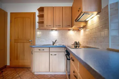 a kitchen with wooden cabinets and a blue counter top at Apartment Carolina in Ortisei