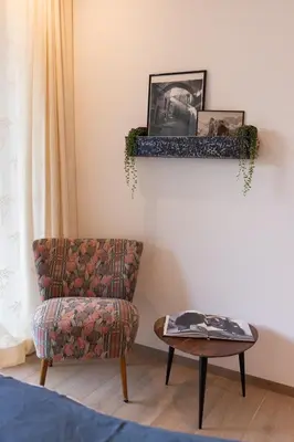 a living room with a chair and a table at Apartment Ando in Brunico