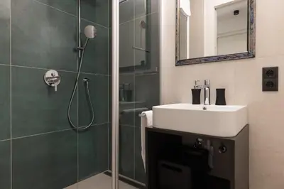 a bathroom with a sink and a shower at Apartment Ando in Brunico