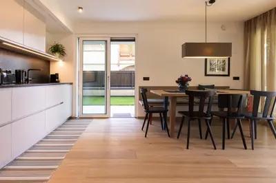 a kitchen and dining room with a table and chairs at Apartment Ando in Brunico