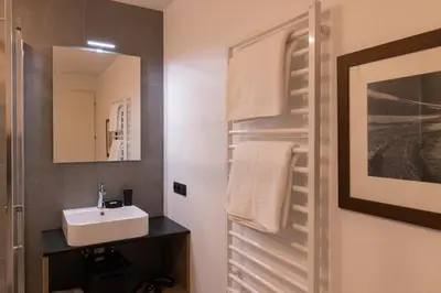a bathroom with a sink and a mirror at Apartment Ando in Brunico