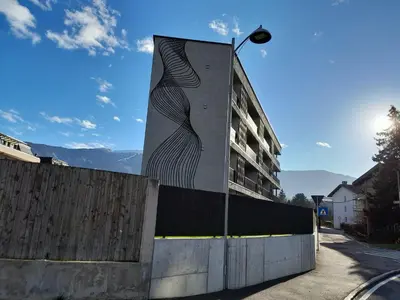 a building with a mural on the side of it at Apartment Ando in Brunico