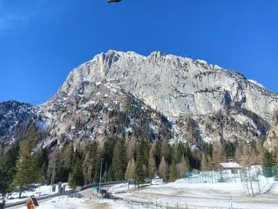 a large mountain with snow on it in front at La casa di Antonello Chiara Alessandro e Ginevra in Malga Ciapela