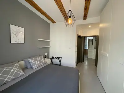 a bedroom with a bed and a chandelier at Haus Gugler in Bolzano