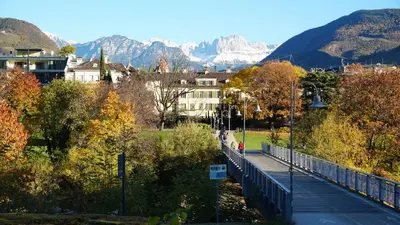 a bridge over a city with mountains in the background at Haus Gugler in Bolzano