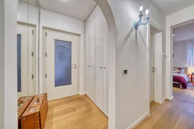 a hallway with white walls and a table and a room at HOMESTWENTY3 - Home one in Caldaro