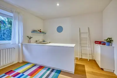 a room with a white counter and a colorful rug at HOMESTWENTY3 - Home one in Caldaro