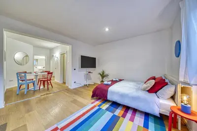 a bedroom with a bed and a dining room with a table at HOMESTWENTY3 - Home one in Caldaro