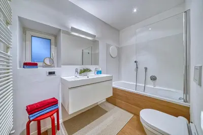 a white bathroom with a sink and a tub at HOMESTWENTY3 - Home one in Caldaro