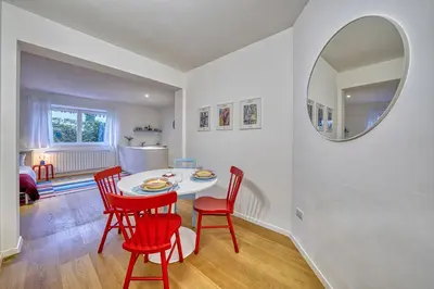 a dining room with a table and chairs and a mirror at HOMESTWENTY3 - Home one in Caldaro