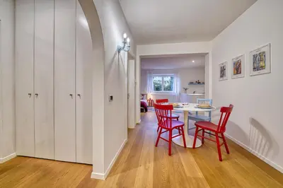 a dining room with red chairs and a table at HOMESTWENTY3 - Home one in Caldaro