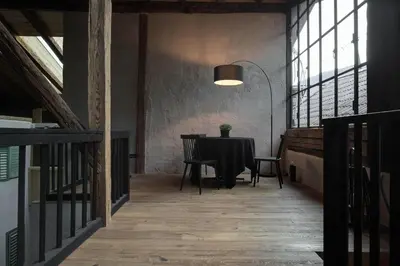a dining room with a table and chairs and windows at Attica 54 Apartments Merano in Merano