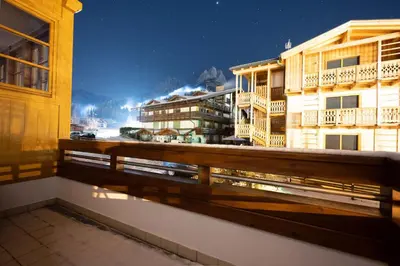 a view from a balcony of buildings at night at Cesa Meida 2A in Pozza di Fassa