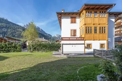 a house in the mountains with a yard at Cesa Meida 2A in Pozza di Fassa