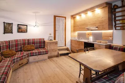 a living room with a couch and a table at Charming Studio in Chiave