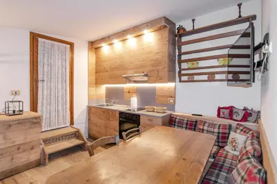 a kitchen with a wooden table and a stove at Charming Studio in Chiave