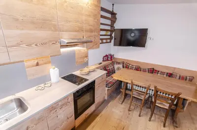 a kitchen with a table and a sink and a stove at Charming Studio in Chiave