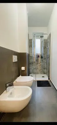 a bathroom with two sinks and a shower at Green View: il verde in città in Bolzano