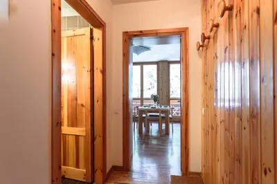 a hallway with a door leading to a dining room at Loft a Canazei vicino alle piste vista Marmolada in Alba di Canazei