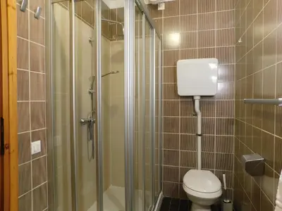 a small bathroom with a toilet and a shower at Loft a Canazei vicino alle piste vista Marmolada in Alba di Canazei