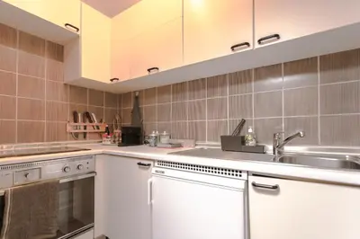 a kitchen with white cabinets and a sink at Loft a Canazei vicino alle piste vista Marmolada in Alba di Canazei