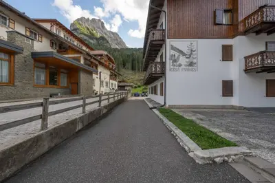 a street in a mountain village with buildings at Cesa Ariale in Canazei