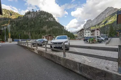 a couple of cars are parked on a bridge at Cesa Ariale in Canazei