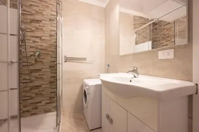 a bathroom with a sink and a toilet and a shower at Cesa Ariale in Canazei