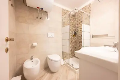 a bathroom with a toilet and a sink and a shower at Cesa Ariale in Canazei