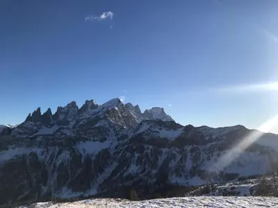 an airplane flying over a snow covered mountain at Il nido dei gufi in Falcade