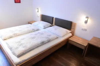 a bed with two pillows on it in a room at Haus Fulterer in Siusi