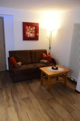 a living room with a couch and a coffee table at Haus Fulterer in Siusi