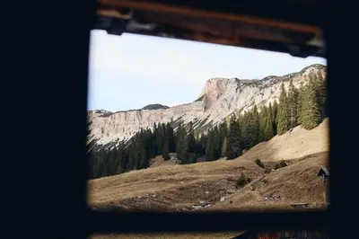 a view of a mountain from a window at Rifugio Malga Ra Stua in Cortina dʼAmpezzo