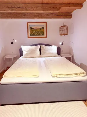 a bedroom with a large bed with white sheets at Holy View Apartment in Bolzano