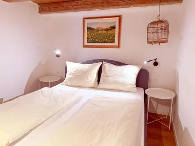 a bedroom with a bed and a bird cage on the wall at Holy View Apartment in Bolzano