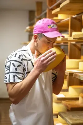 a man in a pink hat is smelling a banana at Starkenfeldhütte in Rodengo
