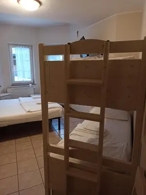 a room with two bunk beds and a bed at Villa San Carlo in Pozza di Fassa