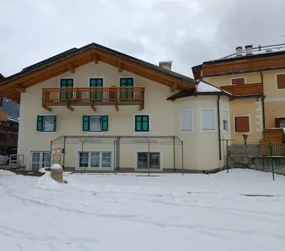 a large house with a balcony on top of it at Villa San Carlo in Pozza di Fassa