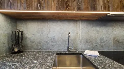 a kitchen sink with a faucet on a counter at Villa Dolomiti in Ortisei