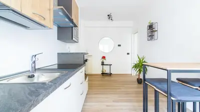 a kitchen with a sink and a counter top at Cloudberry Home in Merano