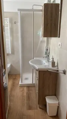 a bathroom with a sink and a shower at CasaMau Bilo in Pera