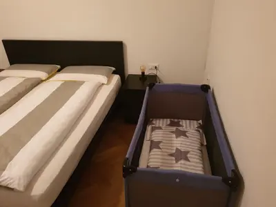 a bedroom with two beds and a suitcase at Appartamento del CONTE a Merano, con piscina, leggere attentamente le info o chiamare direttamente l'host! in Merano
