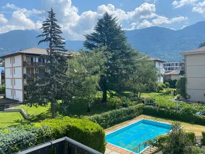 an apartment with a swimming pool and trees and buildings at Appartamento del CONTE a Merano, con piscina, leggere attentamente le info o chiamare direttamente l'host! in Merano