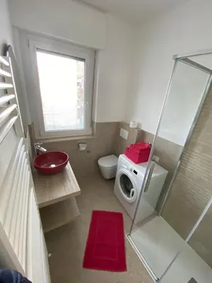 a bathroom with a shower and a toilet and a sink at Appartamento del CONTE a Merano, con piscina, leggere attentamente le info o chiamare direttamente l'host! in Merano